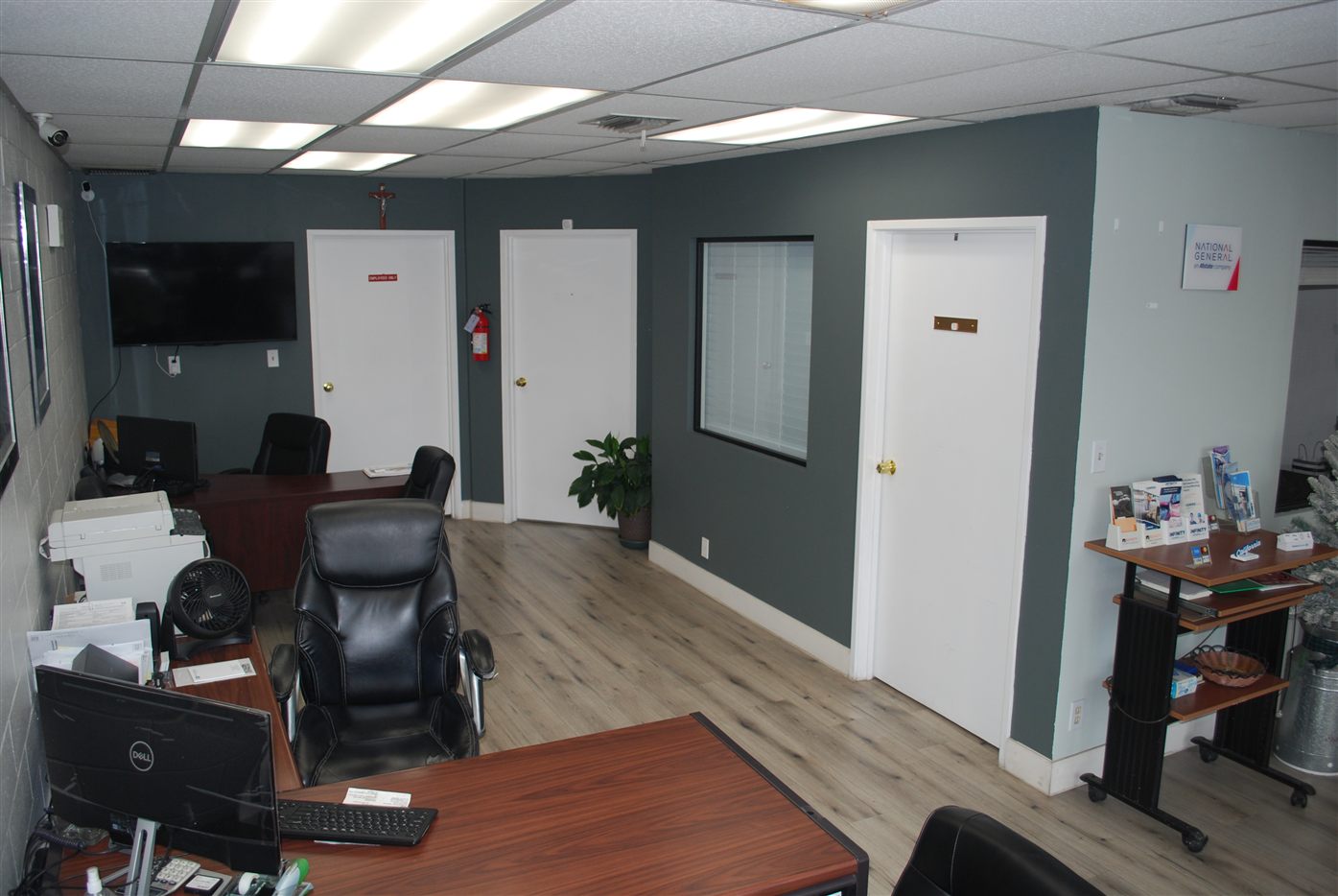 Insurance folders, keys, and policy documents on an Original Insurance broker desk